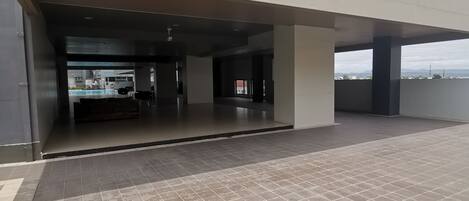 A building entrance with a covered area and a tiled floor.