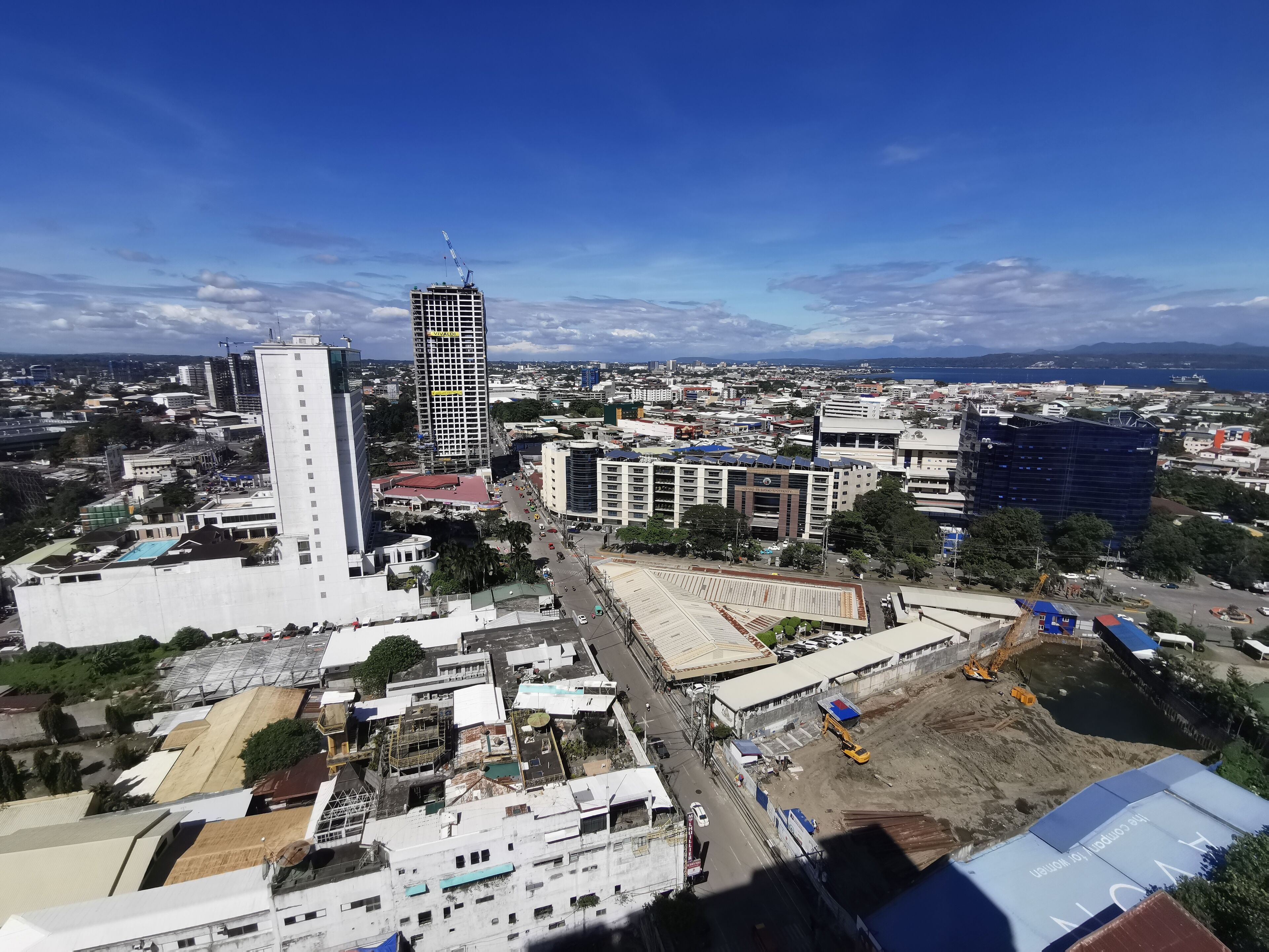 A cityscape with various buildings, including a tall skyscraper and several mid-rise structures.