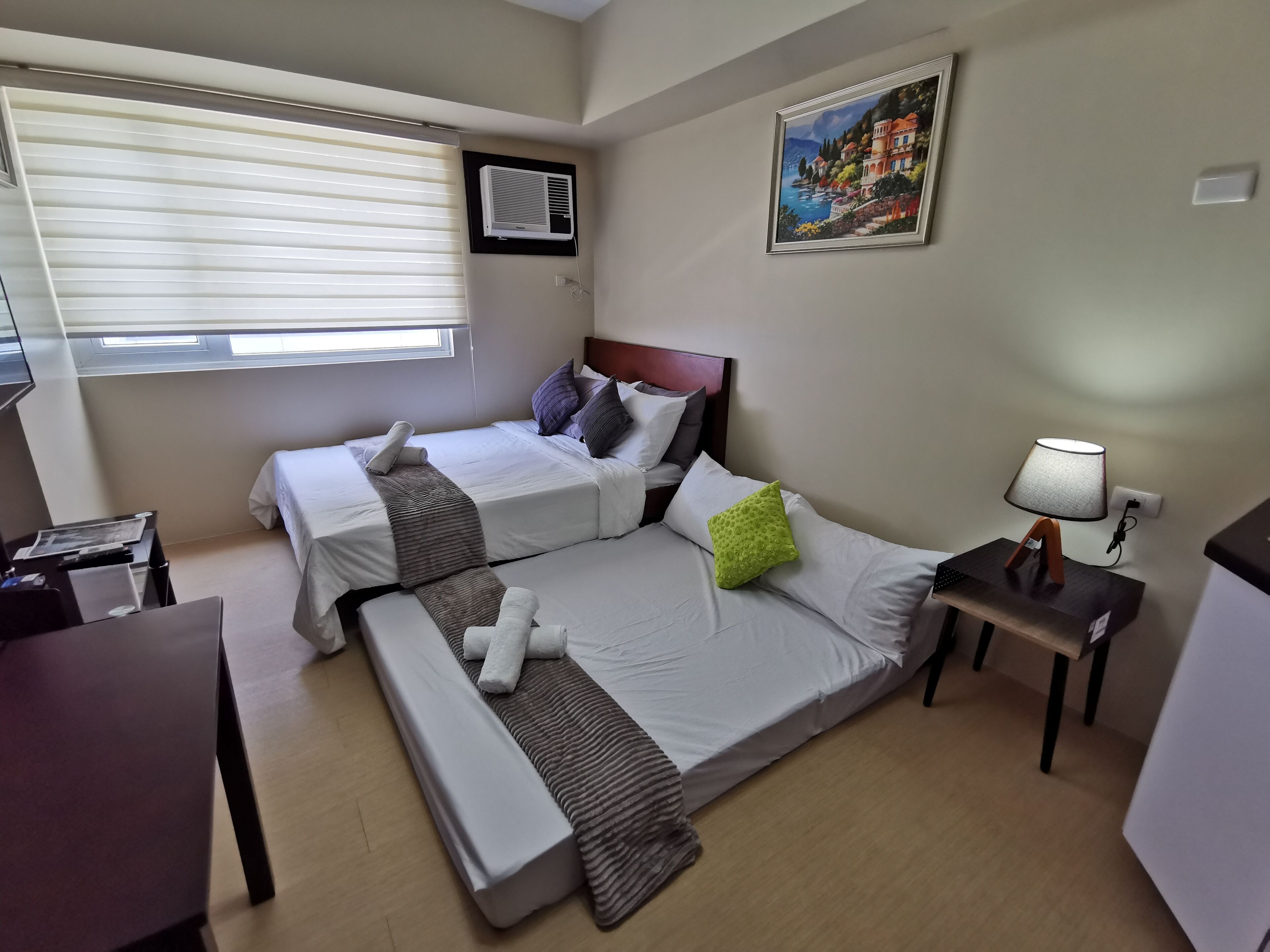 Premium bedding, desk, laptop workspace, blackout curtains
