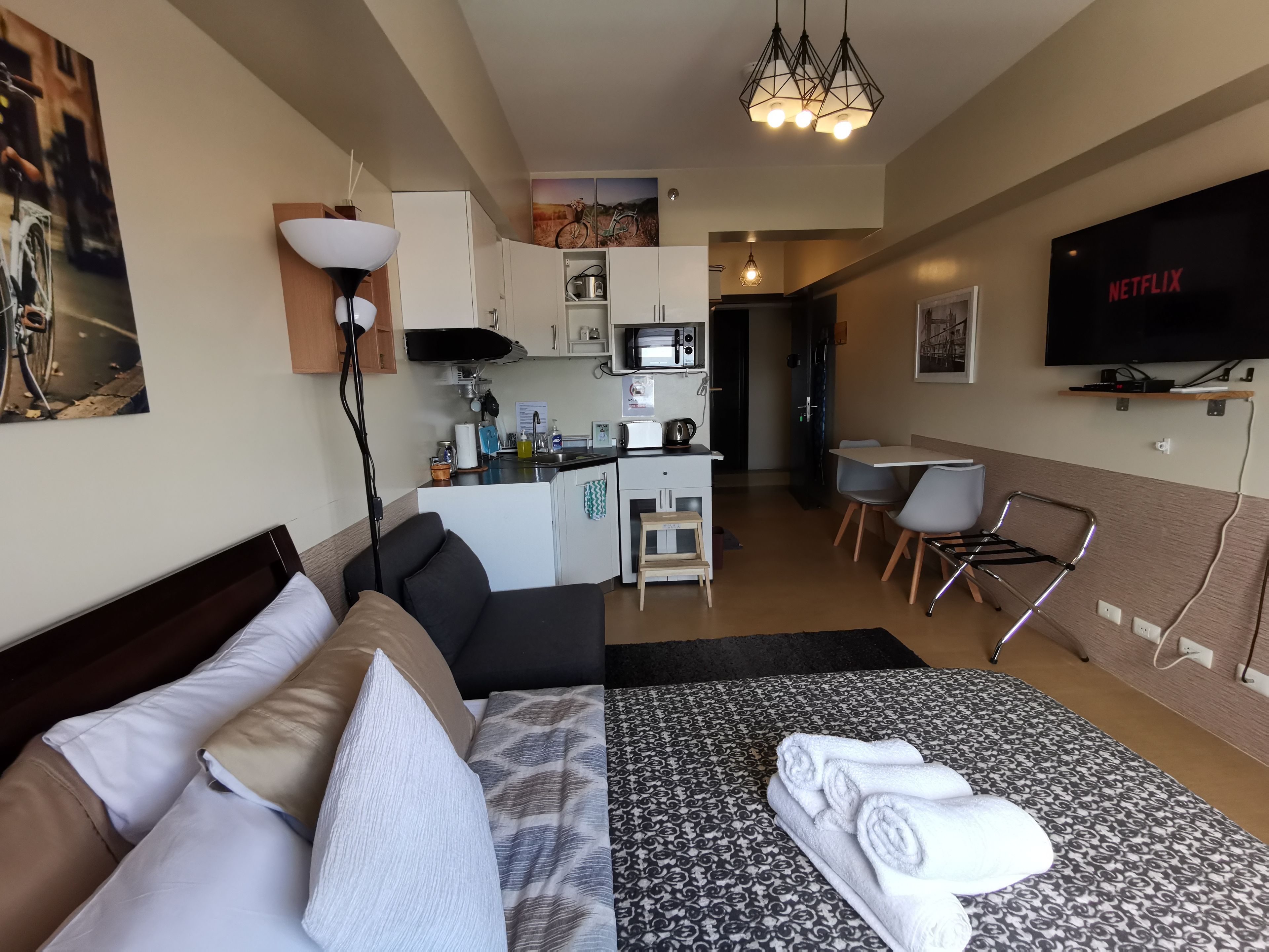 Premium bedding, desk, laptop workspace, blackout drapes
