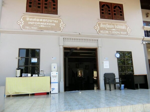 A building with a signboard for information and a welcome sign for Kengtaphu Resort.