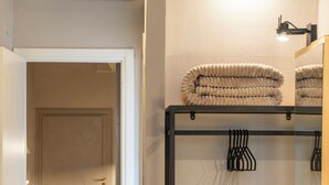A modern bathroom with a towel rack, a toilet, and a shower area. - PALAZZO DEL PAPA  (Siena)