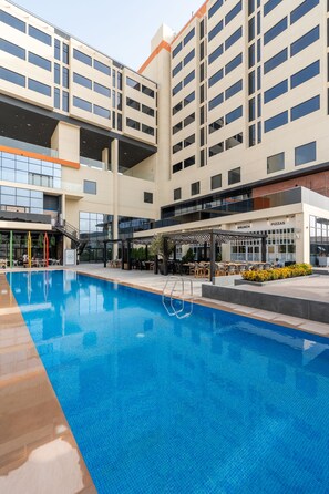 Outdoor pool, open 7:00 AM to 6:00 PM, pool umbrellas, pool loungers - Studio One Hotel (Dubai)