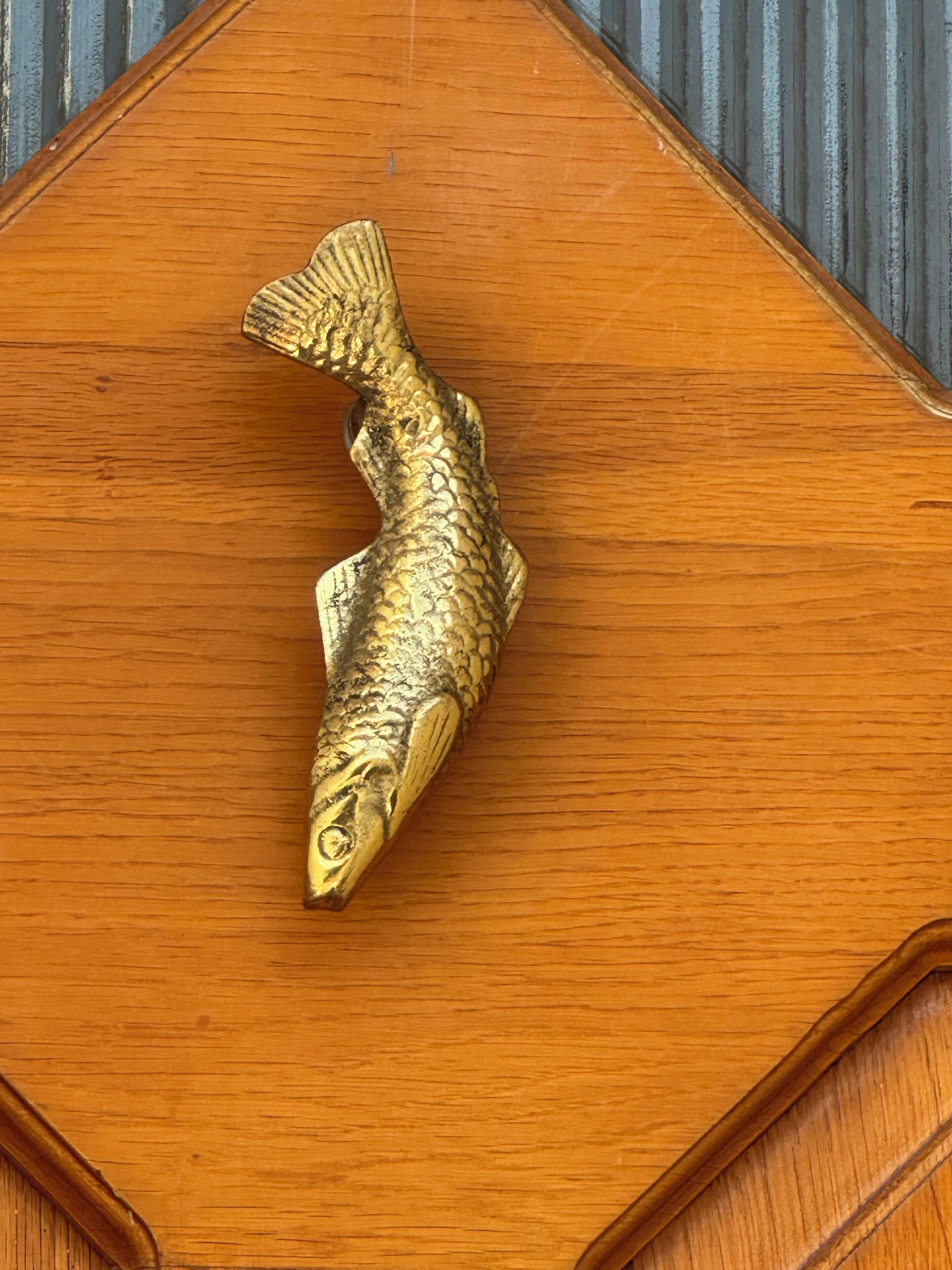 A wooden table with a fish-shaped object on it.