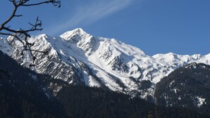 A snow-covered mountain range with clear skies.
