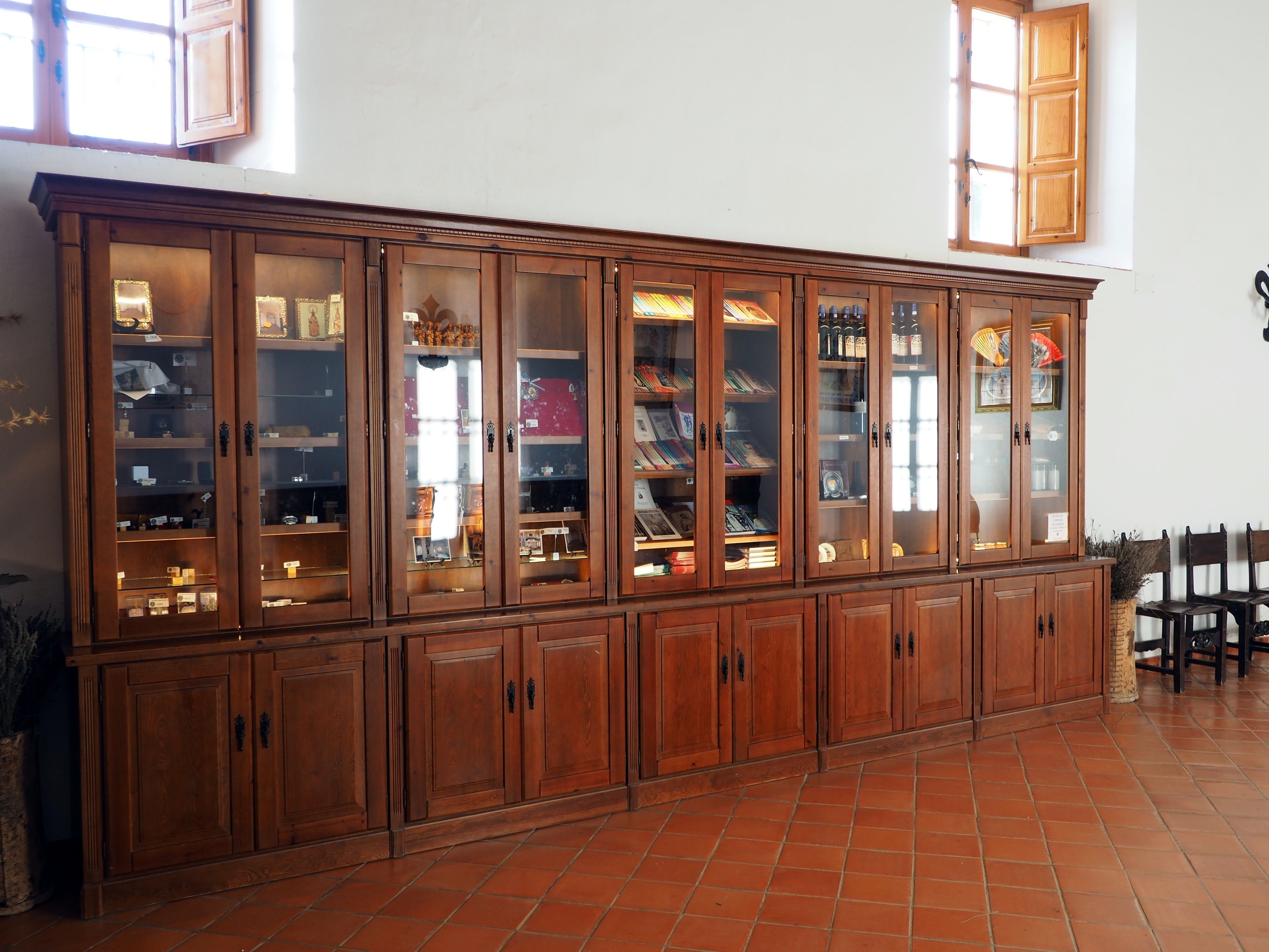 A large wooden cabinet with multiple glass doors, likely used for displaying items.