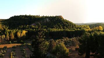 A mountainous landscape with dense forests and a clear sky.