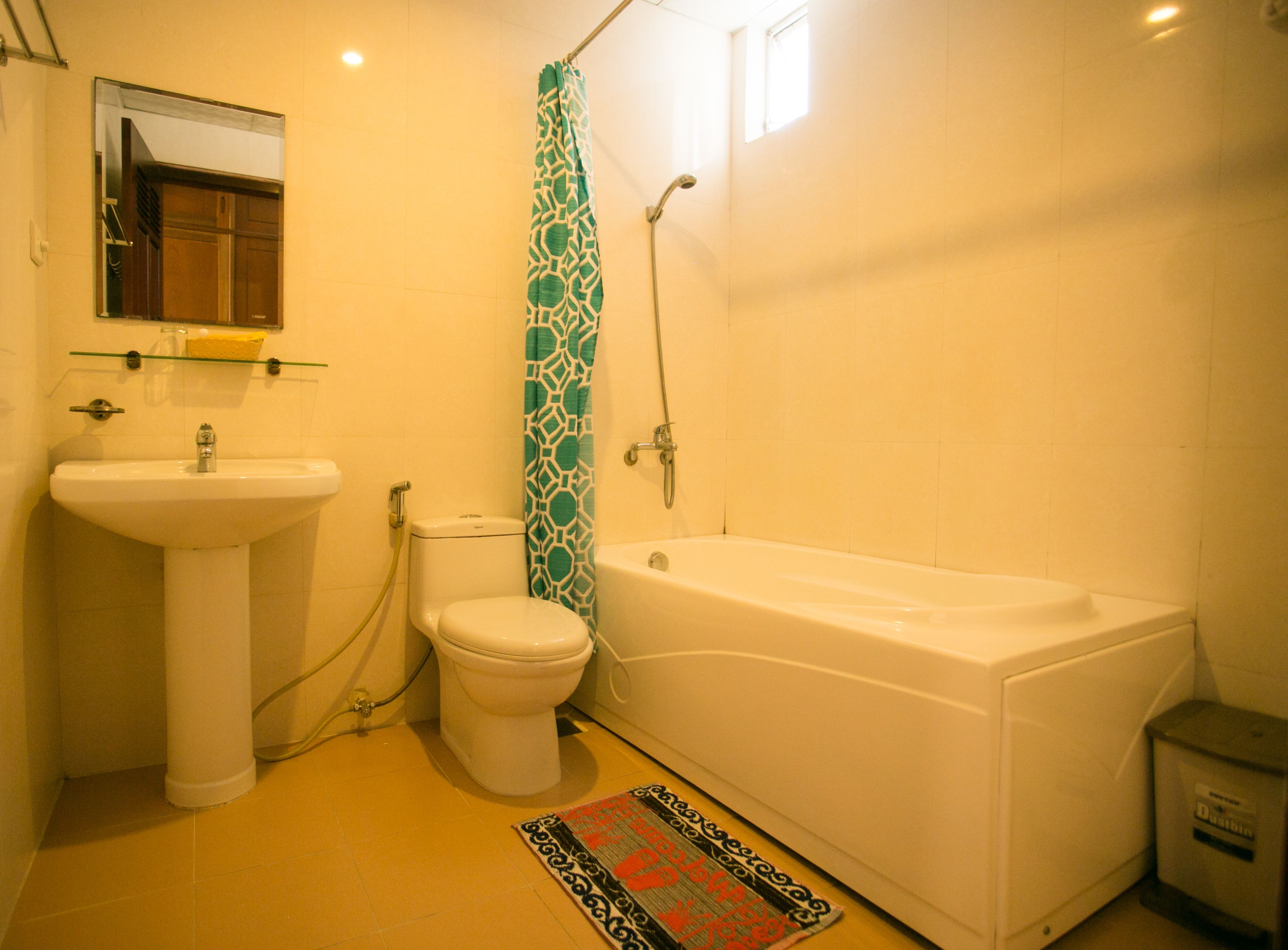 A bathroom with a sink, toilet, and bathtub.