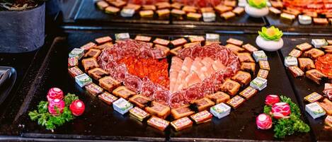 A variety of food items, including meats and packaged goods, arranged on a table.