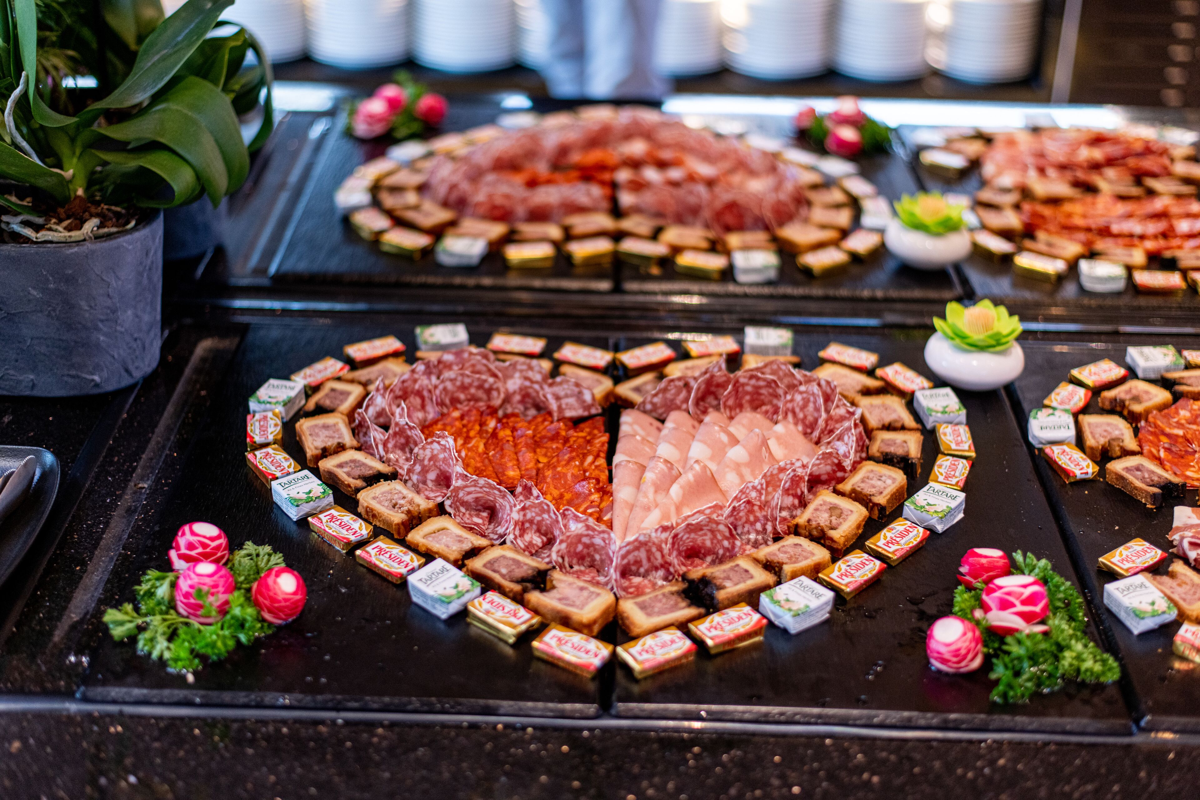 A buffet with various food items arranged on a table.