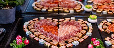 A buffet with various food items arranged on a table.