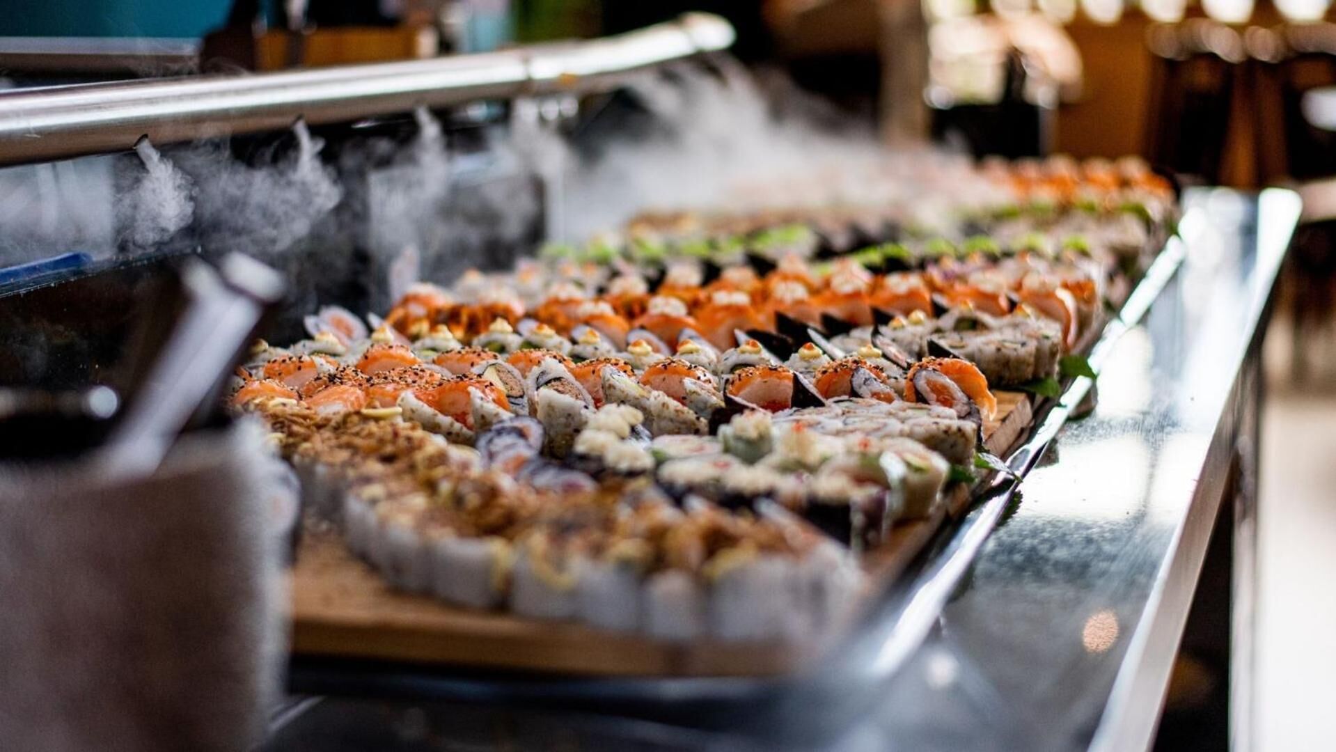 A buffet with various sushi dishes.