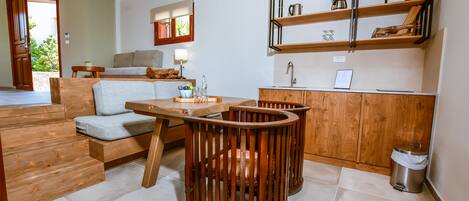 A modern kitchen with wooden cabinets, a built-in sink, and a dining area with a wooden table and chairs.