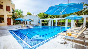 Seasonal outdoor pool, open 10:00 AM to 6:00 PM, pool umbrellas