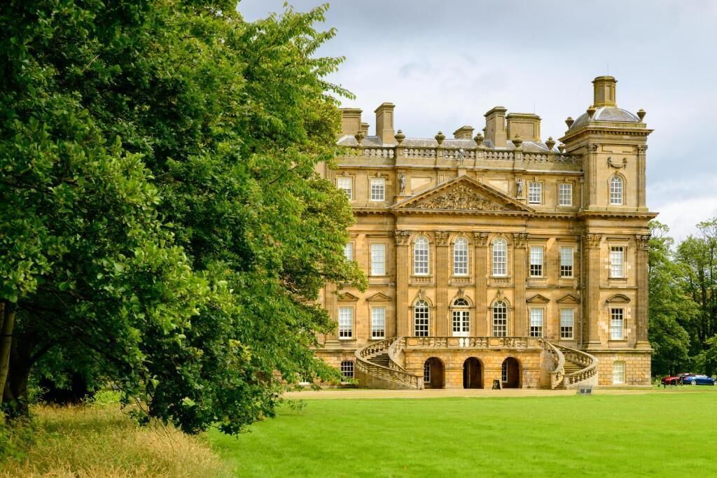 A large, historic building with multiple windows and a grand entrance.