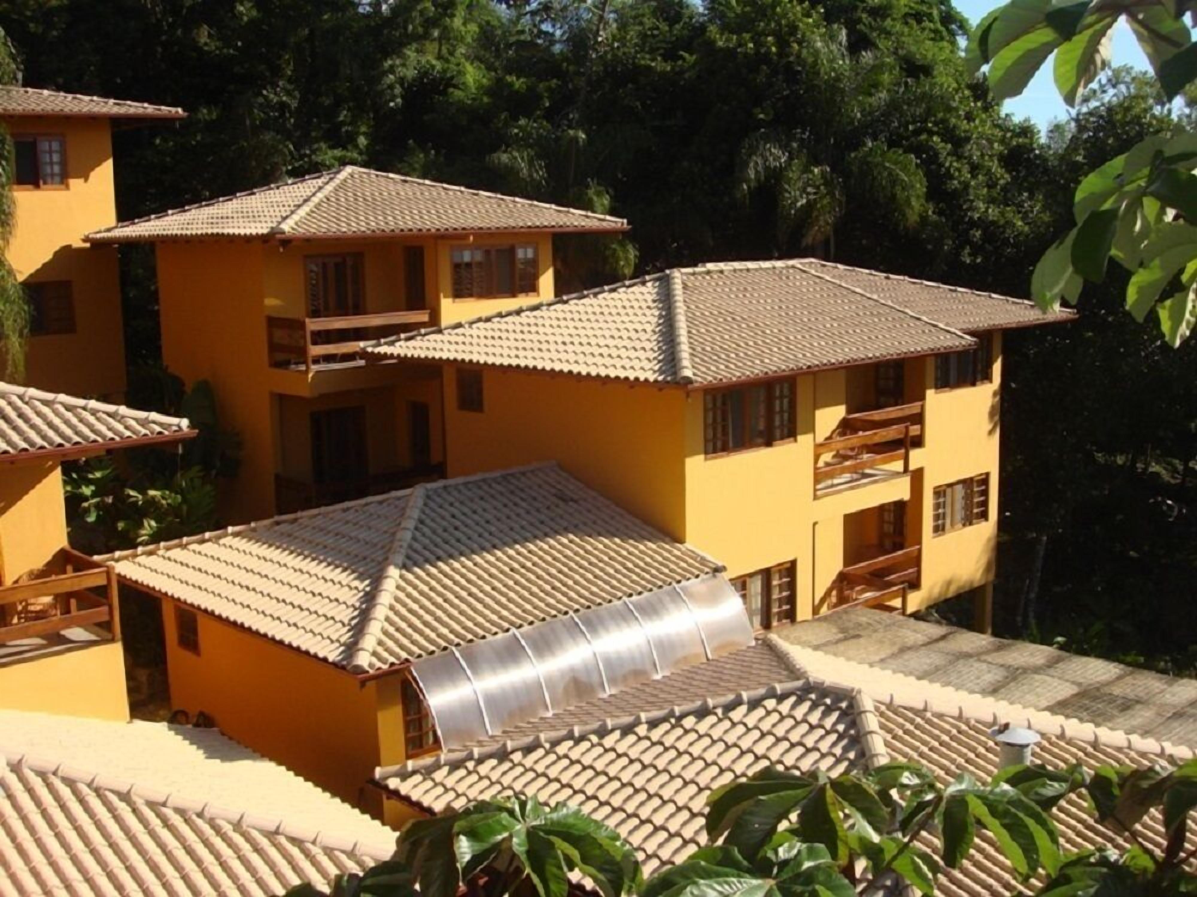 A model of a multi-story building with a tiled roof, balconies, and a central courtyard.