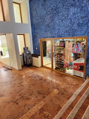 Enter a stylish lobby with a unique blue patterned wall, ATM and shoe display.
