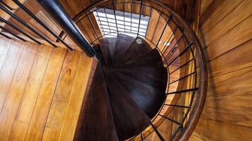 Una escalera de caracol con paredes de madera y barandillas de metal.