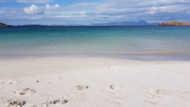 A beach with clear water, white sand, and distant mountains. - Mellon Udrigle "Heaven on Earth",Luxury 6 bed Beach House, sea views (Scottish Highlands)
