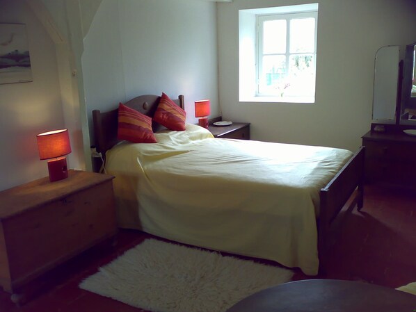 A bedroom with a bed, bedside tables, a nightstand, a lamp, a window, and a mirror. - Spacious Farmhouse with Private Pool. Ideal for 10 adults. (Jaulnay)
