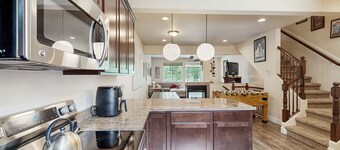 Modern riverfront condo with hot tub, entertainment & river views