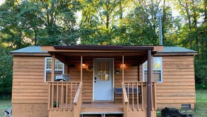 A small wooden cabin with a front porch, a door, and a window. - Jewell between Fall Creek Falls, Burgess Falls and Rock Island State Parks (Sparta)