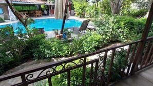 A pool area with a wooden deck, lounge chairs, and a covered seating area. - Jasmin Apart Hotel (Fethiye)