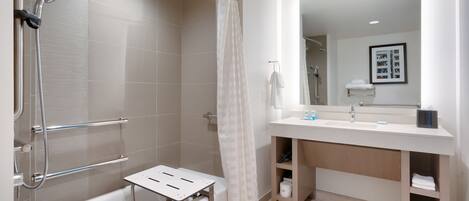 A modern bathroom with a shower, bathtub, and vanity.