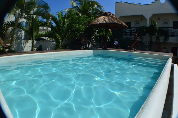 Una piscina al aire libre, tumbonas