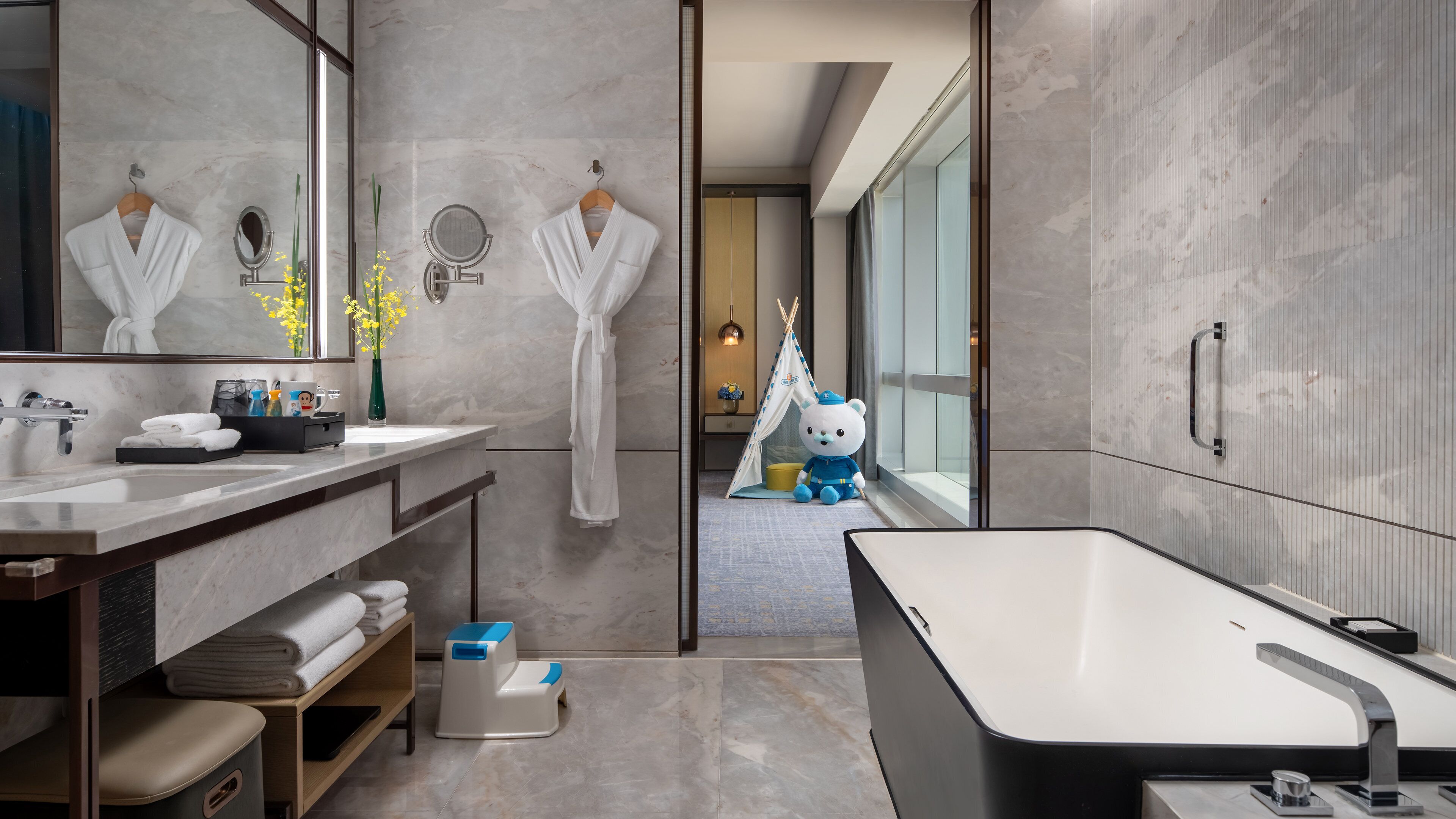 Un baño moderno con una bañera grande, un tocador con espejo y una zona de ducha.