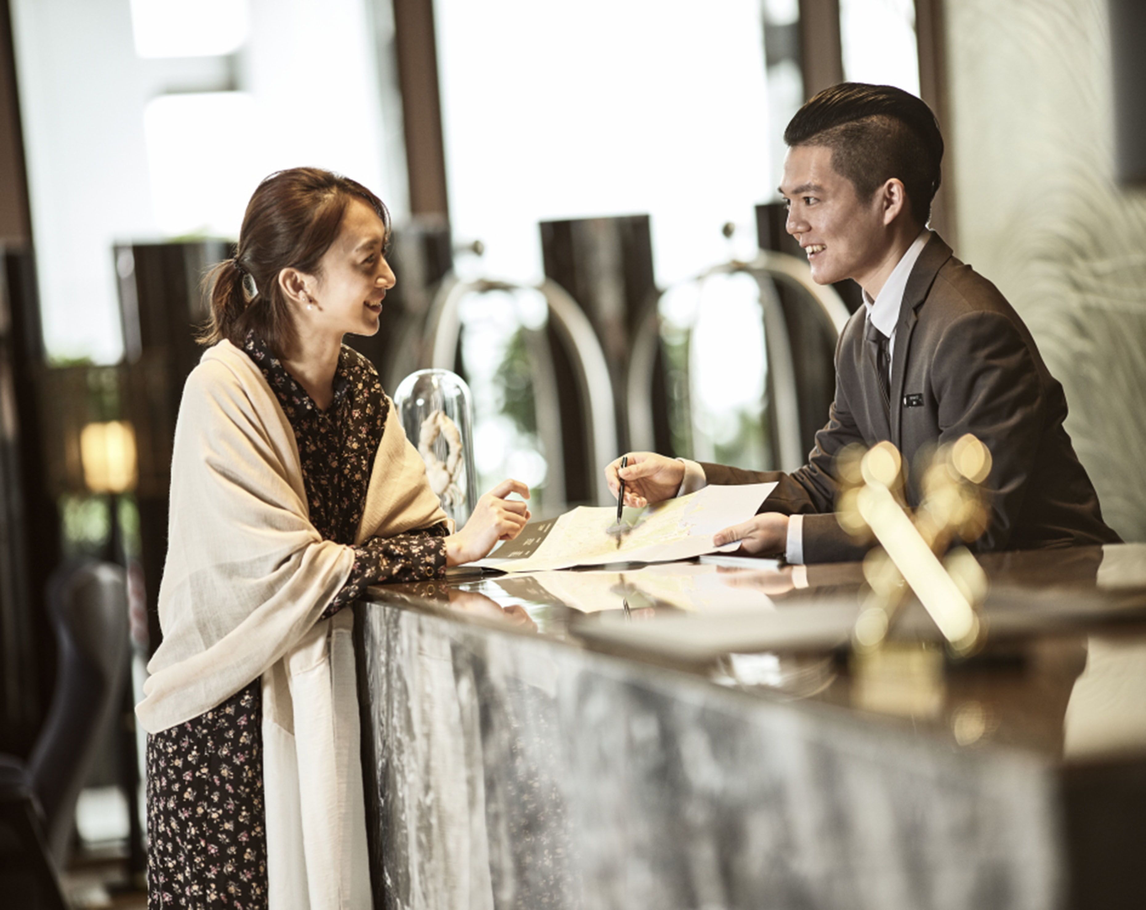 A reception desk with a man and a woman.