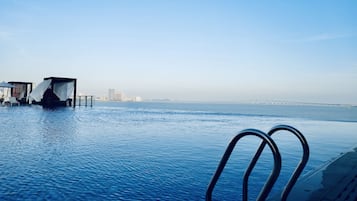 Seasonal outdoor pool, open 7:00 AM to 10:00 PM, pool loungers
