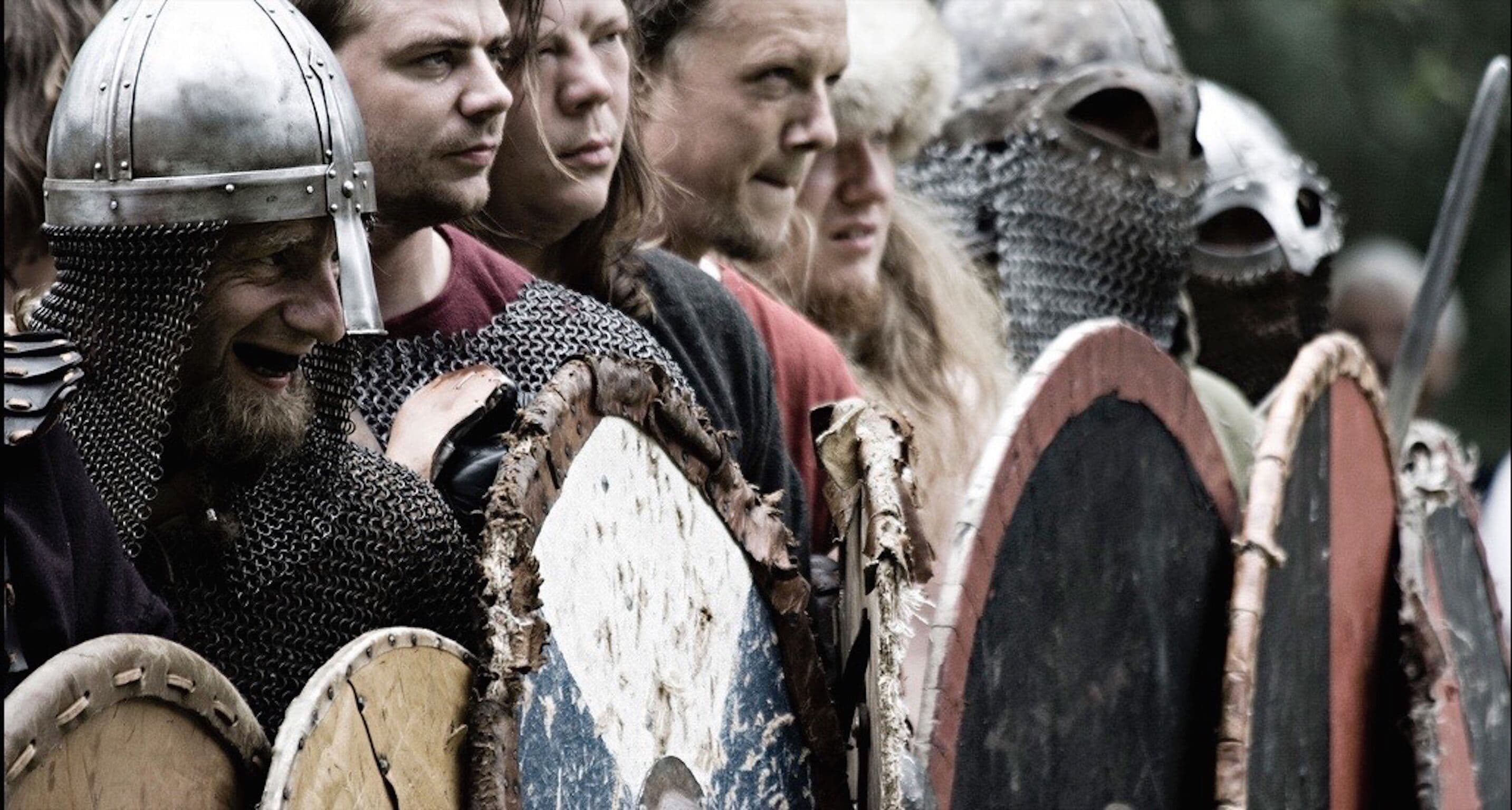 A group of people in medieval armor, including chainmail and helmets, suggesting a historical reenactment or event.