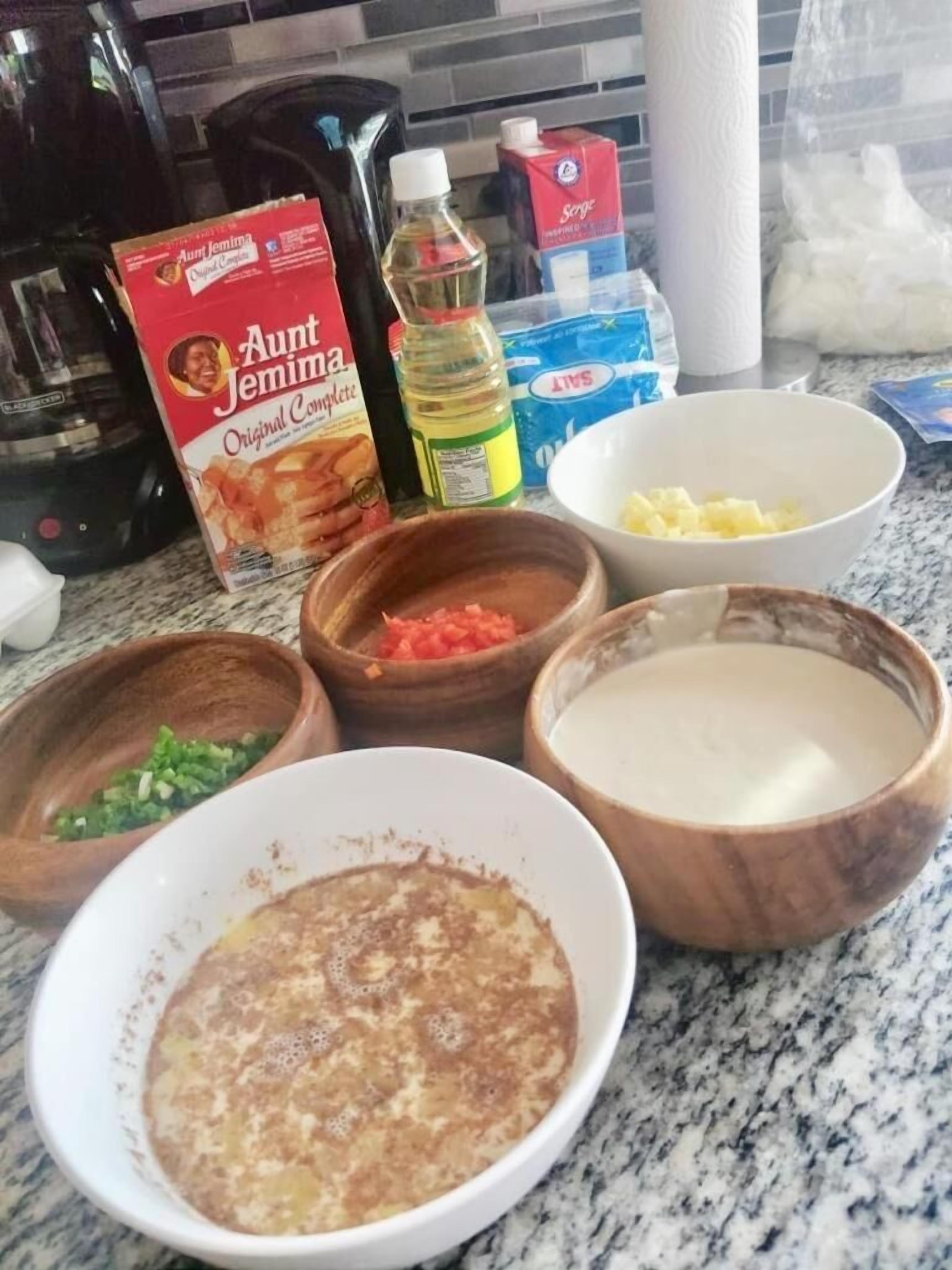 A kitchen counter with various food ingredients and cooking utensils.
