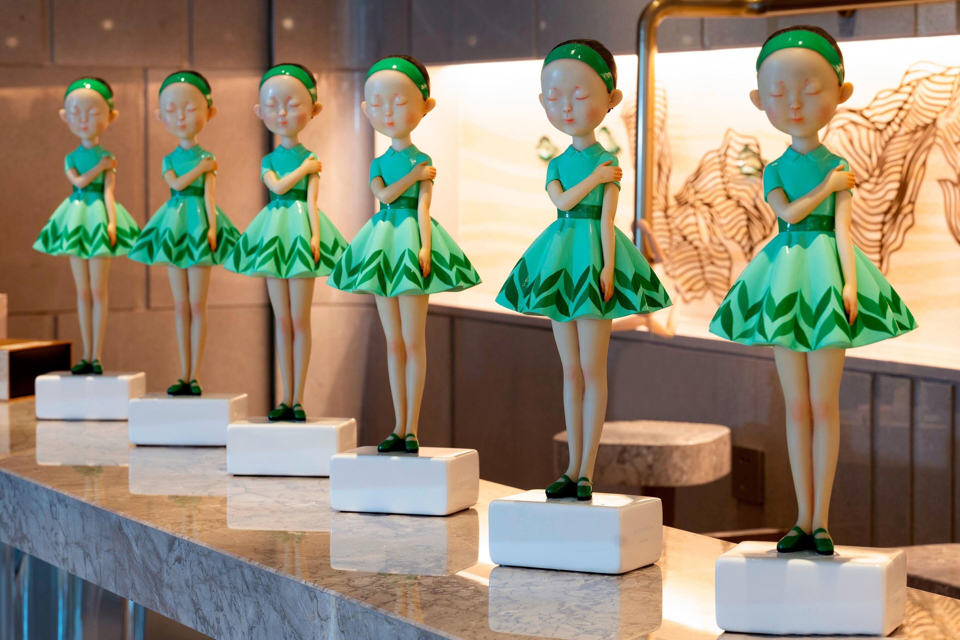 A row of figurines on a marble counter.