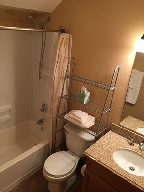 Bathtub, hair dryer, towels, soap