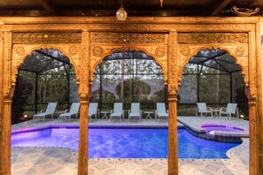 An indoor swimming pool with ornate arches and lounge chairs. - Watersong Resort Six-bedroom (Davenport)