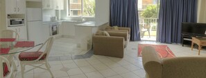 Apartment, 2 Bedrooms, 2 Bathrooms, Garden View | Living area | Flat-screen TV, DVD player