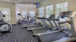 A fitness center with treadmills, elliptical machines, and a stationary bike. - Windsor Palms Resort Three-bedroom (Kissimmee)