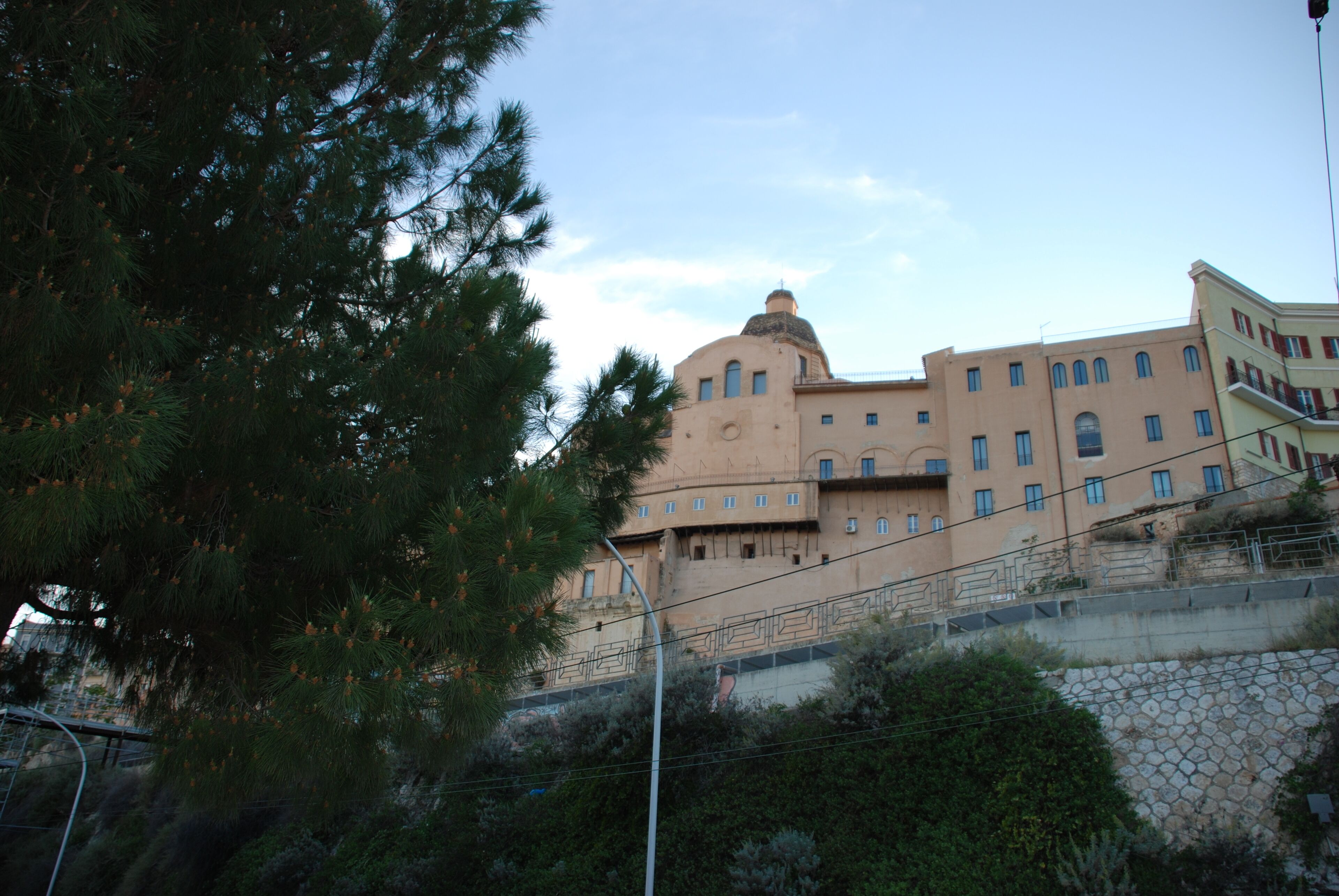 A large building with multiple windows and a dome structure.