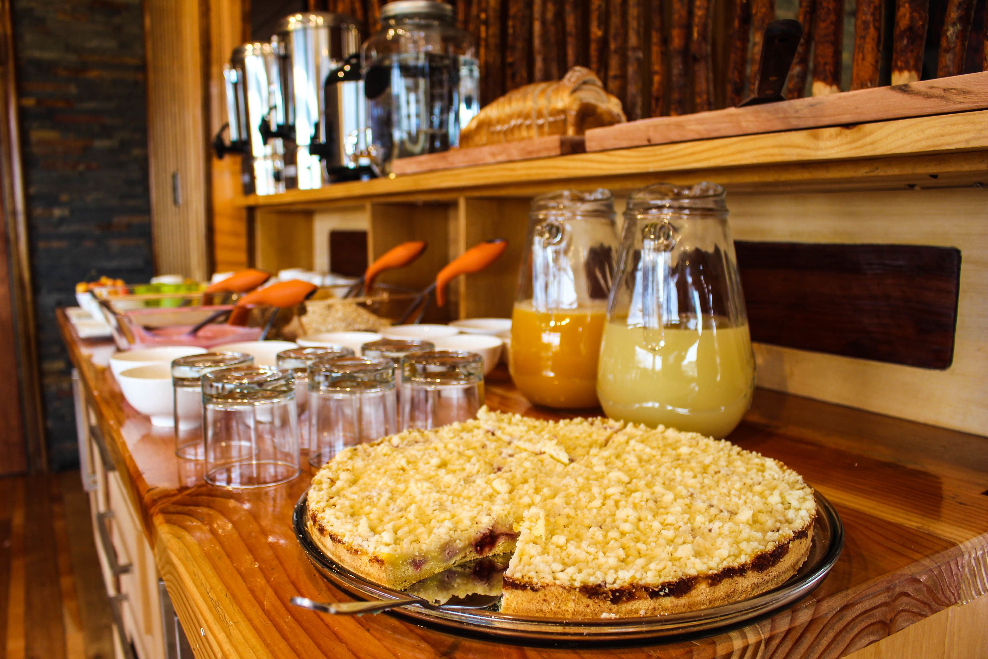 A breakfast buffet with a variety of food items and beverages.