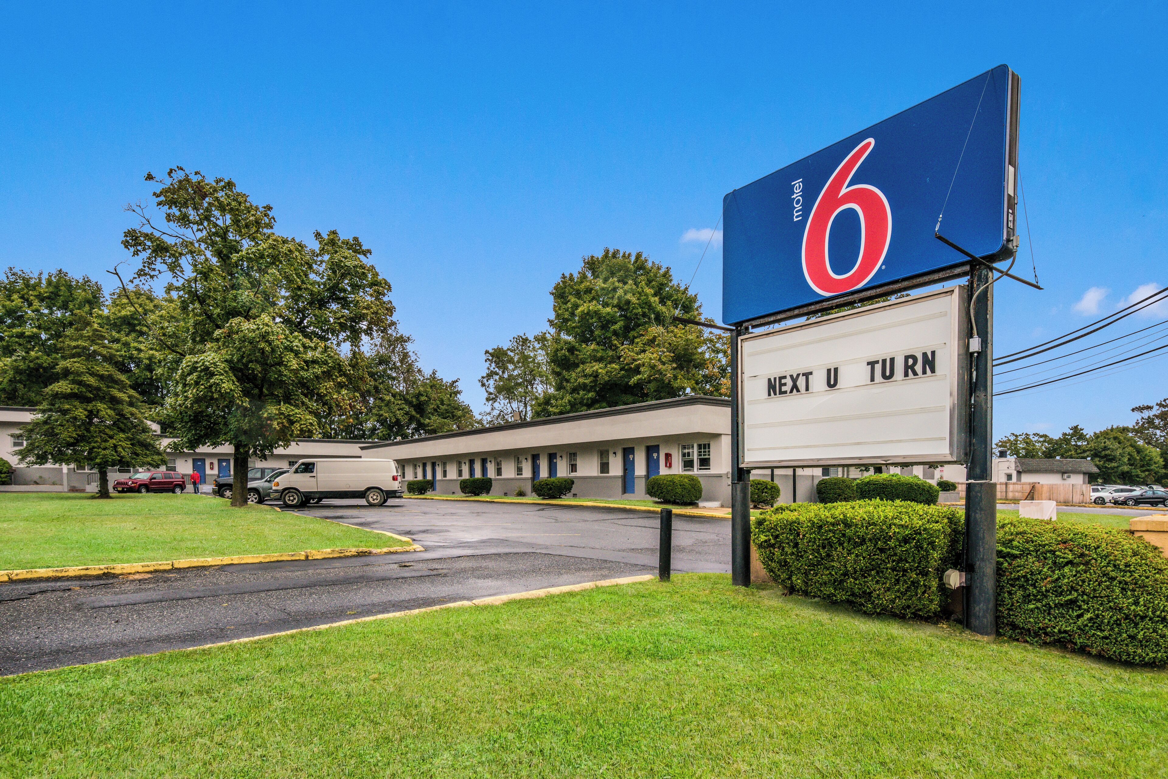 A motel with a large sign indicating it is number 6.