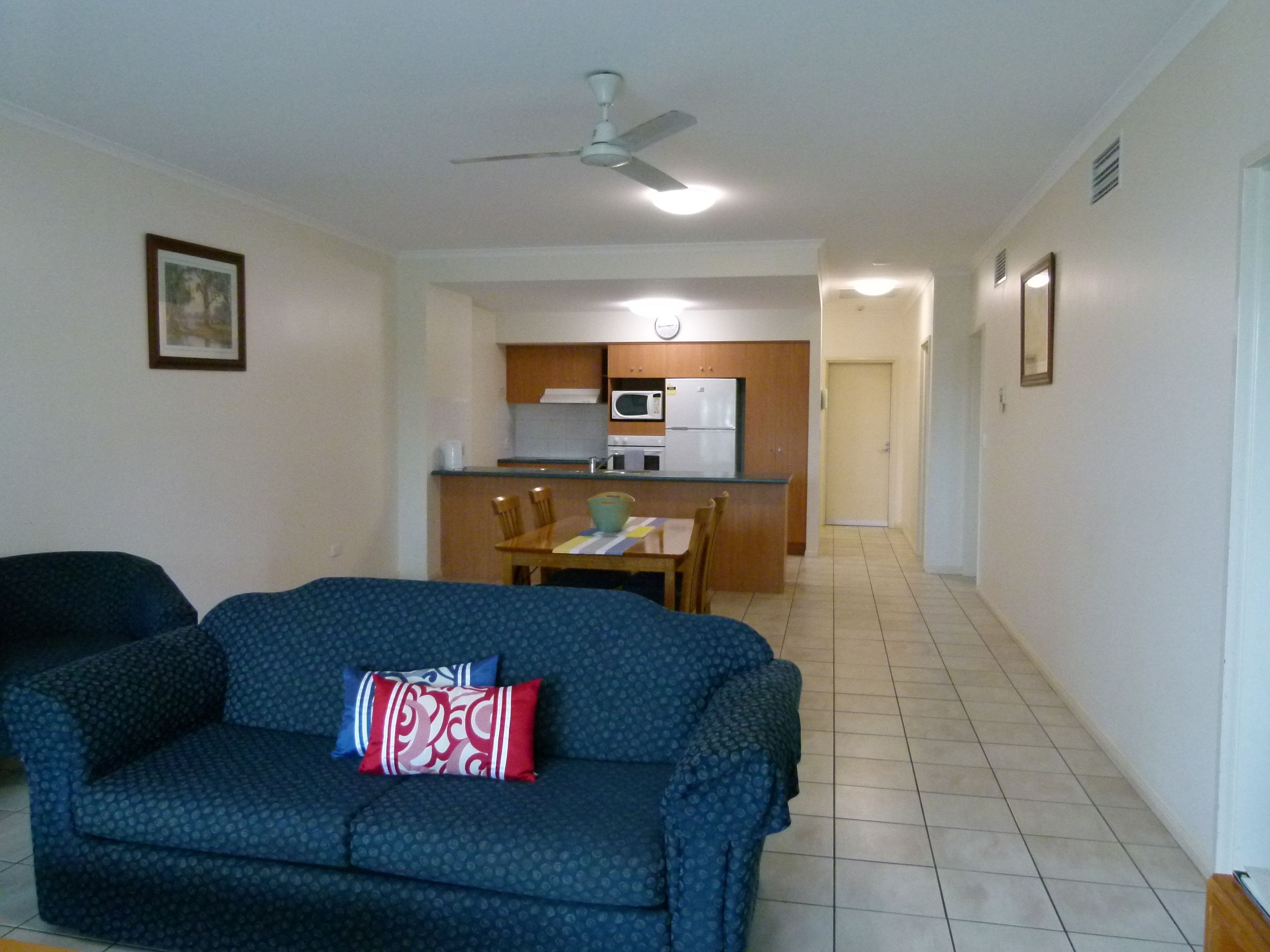 A living room with a sofa and a dining area with a table and chairs.
