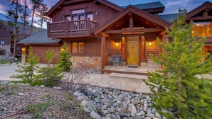 A wooden cabin with a balcony, stone steps, and a wooden door. - Spacious Frisco Cabin w/ Hot Tub, Sauna & Mountain Views—Minutes to Ski Resorts! (Frisco)
