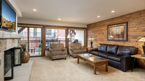 A living room with a fireplace, two armchairs, a sofa, and a coffee table. - Montaneros 321 -1 Bedroom Platinum (Vail)