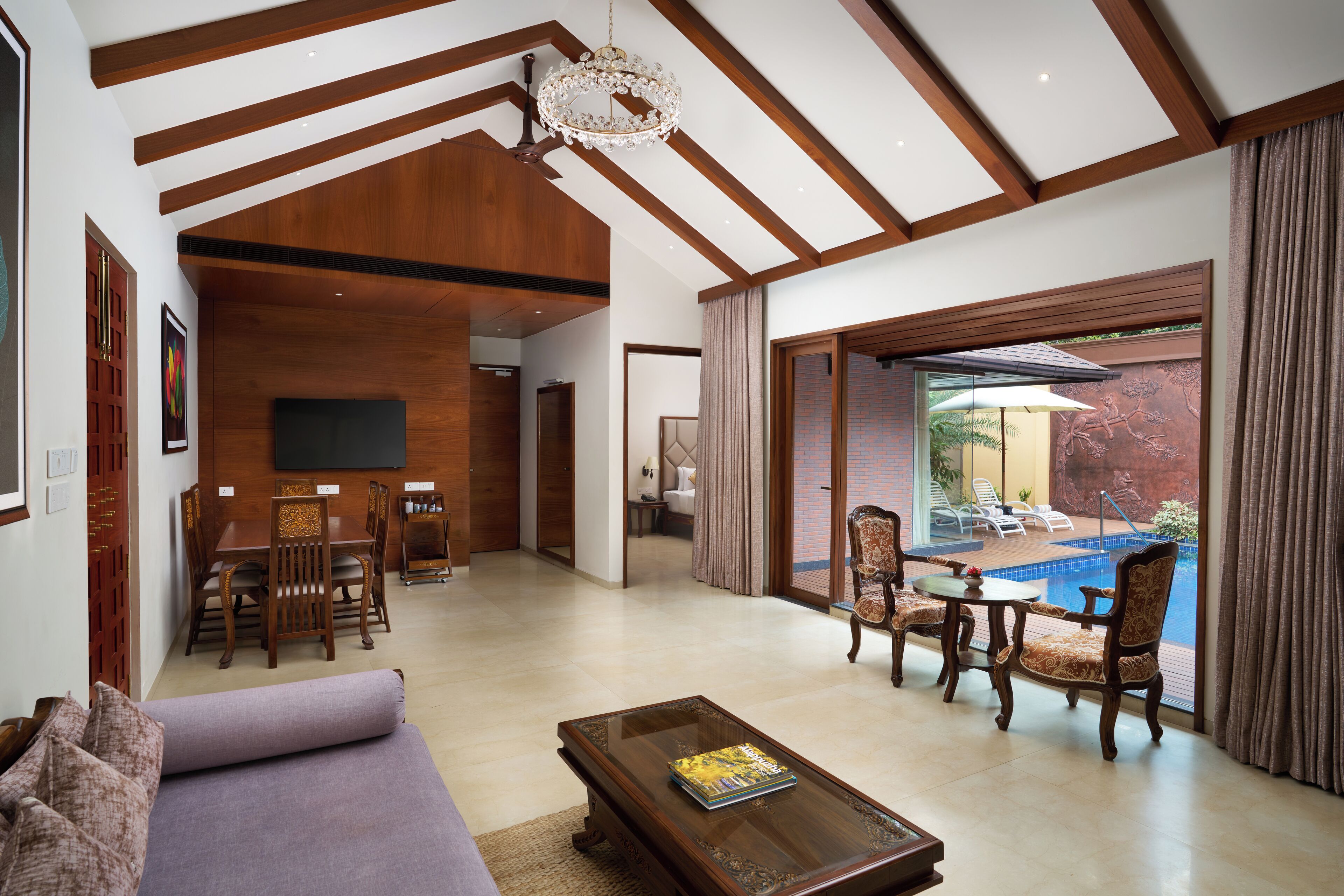 A spacious living area with a dining set, a sofa, and a coffee table.