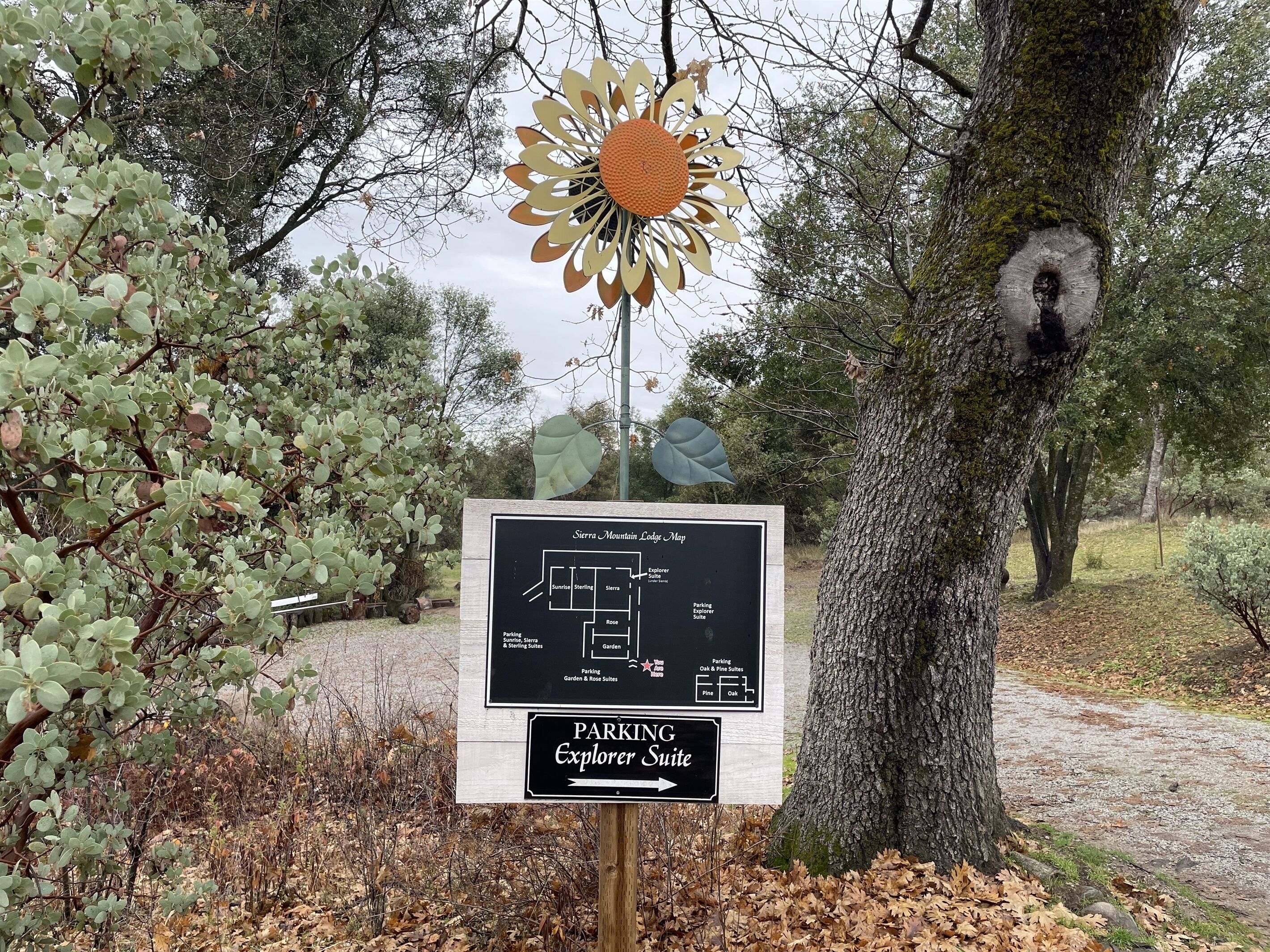 A map sign for Sierra Mountain Lodge with a parking sign for Explorer Suite.