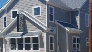 A two-story house with a gabled roof and a number '420' on the side.