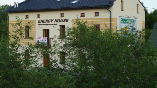 Un edificio de dos pisos con un cartel que dice "ENERGY HOUSE" y otro cartel que anuncia "ENERGY LIGHT".