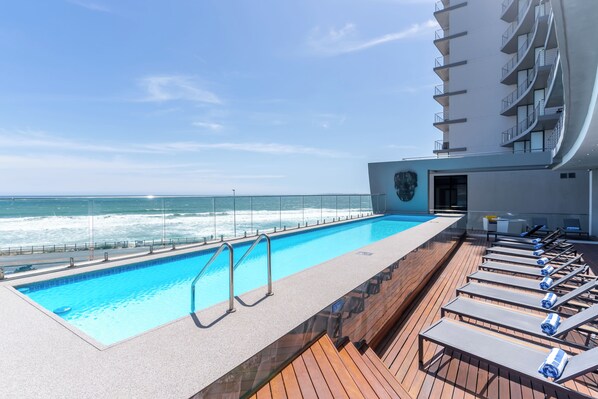 Outdoor pool, open 9:00 AM to 6:00 PM, pool umbrellas, pool loungers